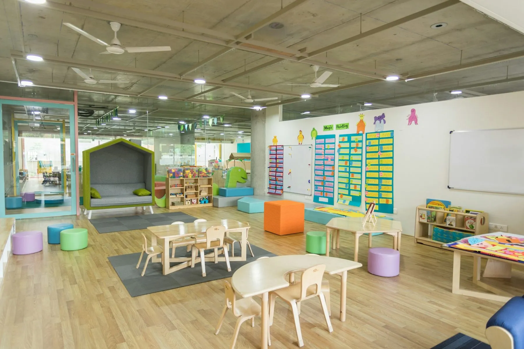 Bright preschool classroom with small tables and chairs